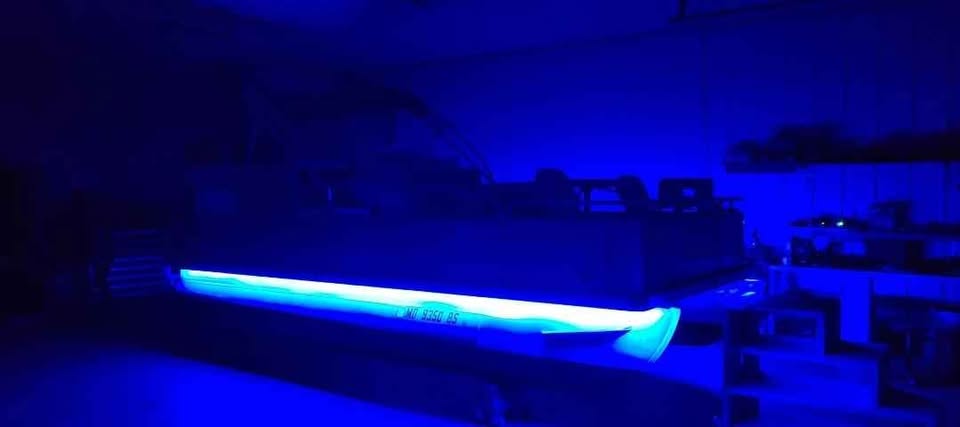 Pontoon Boat with Custom Blue Underglow LED Lighting at Night